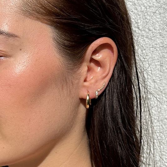 Close up of female brunette model wearing the 18K Gold Filled Classic Clicker Hoop Earring