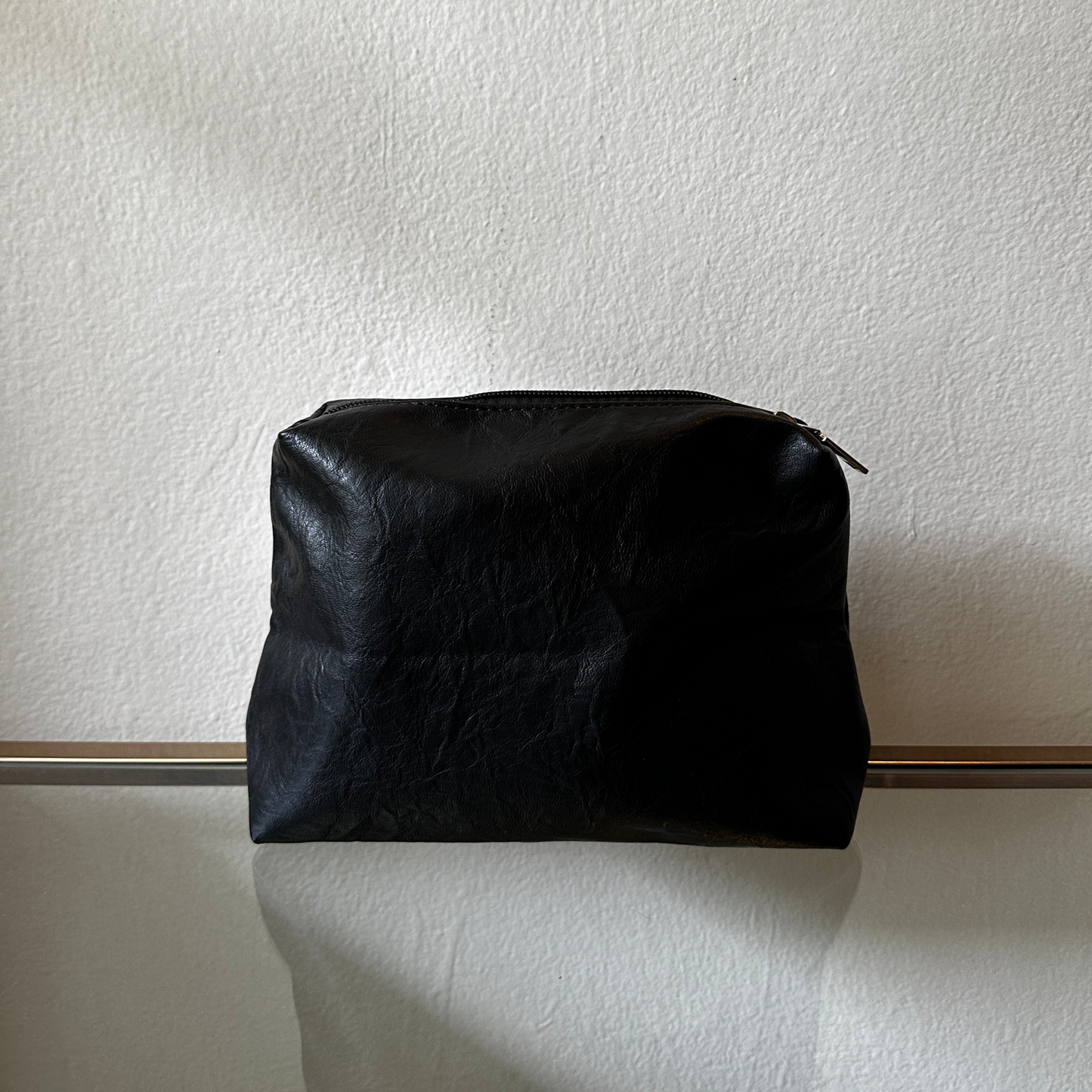The Black Vegan Leather Pouch shown close up from the front angle