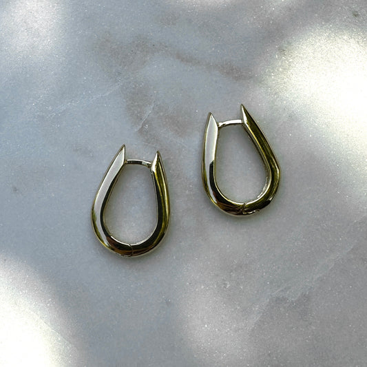 A close up product image of the 18K Gold Filled Chic U-Shaped Hoop Earrings from an above angle