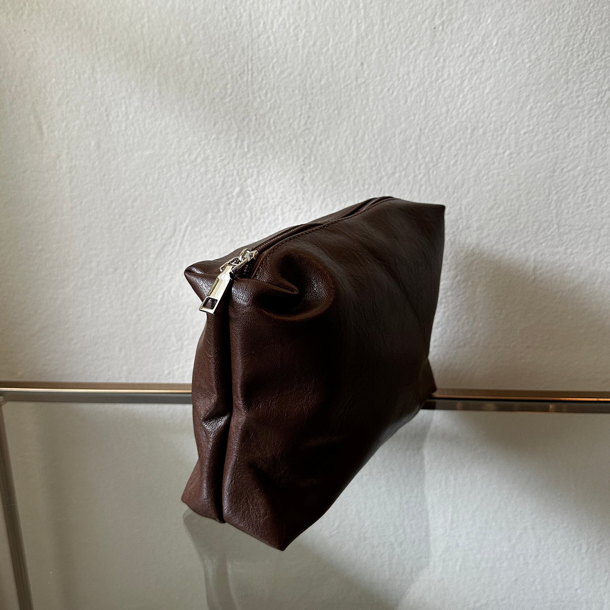 The Brown Vegan Leather Pouch shown at a side angle