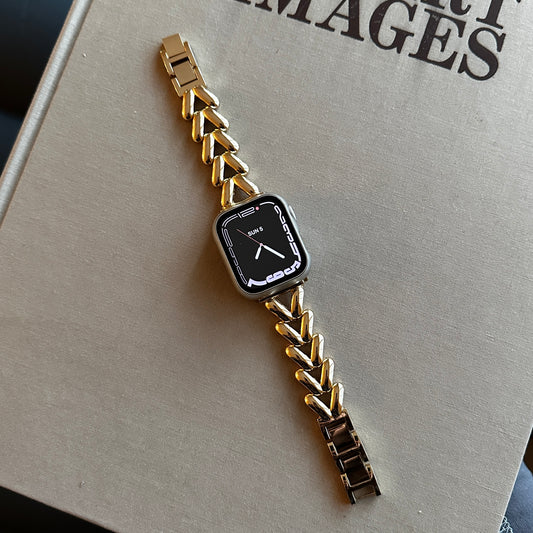 Close up product image of the Gold-Tone Alloy Link Chain Watch Band Compatible with Apple Watch displayed flat across a beige surface